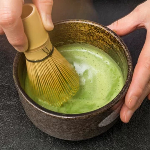 Toronto-sourced matcha being whisked into a smooth green froth